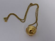 A Lady`s Pendant and Chain, the pendant in the form of our Globe stamped 750 suspended on a box