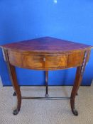 A 1920`s bow fronted flamed mahogany occasional corner table being on ornate legs united with