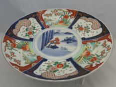 A Decorative Imari Charger stamped to base.  The charger with six segments depicting Chrysanthemums