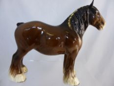 Three Beswick figures of animals comprising a cart horse and two Staffordshire style dogs.