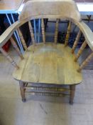 A gentleman`s pine smokers chair having turned legs and stretchers.