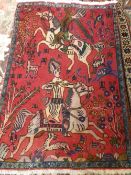 An antique Persian Rug depicting hunting scenes with archers on horseback, approx. 143 x 97 cms.