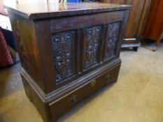 A small Victorian oak blanket box with drawer below, the front having three decoratively carved