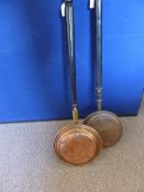 Two vintage copper warming pans, one having an etched lid with foliage and peacock decoration, both