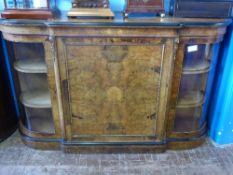 A Mid-Victorian Walnut Credenza, with a central panelled cupboard door opening to reveal a shelf