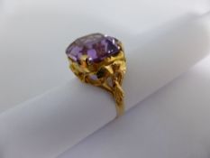 A Ladies Gold Cushion Shaped Amethyst  Dress Ring, ring size N  and stamped 22 K.