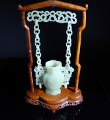 Chinese Qing Dynasty Celadon Jade Suspended Vase, the vase of simple segmented baluster form,