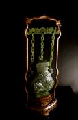 Chinese Qing Dynasty Marbled Deep Green Jade Suspended Vase and Cover, the baluster vase featuring