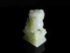 Chinese Pale Celadon Jade Foo Dog, the figure featuring an ornately carved mane and tail with minor