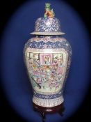 Chinese Qing Dynasty Famille Rose Temple Vase and Cover, the vase featuring a cobalt blue ground