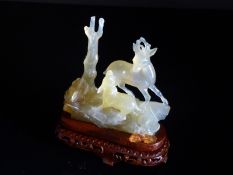 Chinese 20th Century Agate Figure of a Deer and Fawn, the ornately carved deer standing on a rock