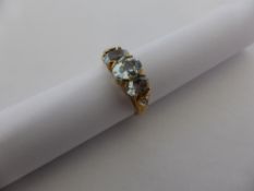 A lady`s 9 ct. gold aquamarine and diamond three stone ring, approx. 2.3 gms.