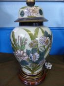 Large Porcelain Table Lamp with floral design on green ground supported on a wooden base with an