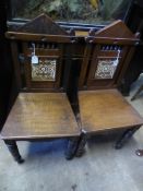 Two Mahogany Hall Chairs, the straight backed hall chairs with central panels featuring an Arts and