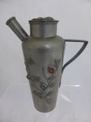 A Chinese Pewter Pouring Jug, the jug with raised floral decoration in the form of a flowering tree