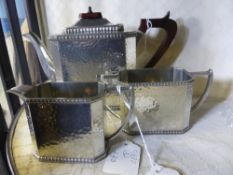 A hammered Craftsman Pewter, Sheffield, Tea Trio comprising Tea pot, Milk Jug and Sugar Bowl.