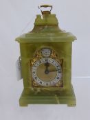 A Green Marble Carriage Clock by C.Sewell of London.The clock featuring gilded cherubs framing a