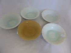 Five celadon coloured Quinbai bowls, with various foliate designs to the centre of each bowl.