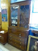 A Georgian Mahogany Bureau Bookcase having four drawers, the fall front enclosing pigeon holes,