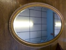 A mahogany framed hall mirror having bevelled glass, approx. 67 x 42 cms.