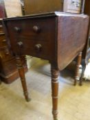 A small mahogany drop leaf table on turned legs and brass castors, approx. 57 x 38 x 73 cms.