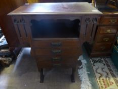 An Edwardian mahogany music cabinet fitted with three drawers and having a shelf to each side, ,