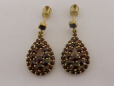 A pair of gold tear drop screw end earrings, approx. 5 gms.