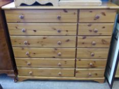 A Pine Chest of Drawers with six long drawers and six short drawers, 99 x 38 x 117 cms.