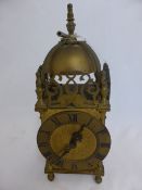 A vintage brass carriage brass clock having filigree decoration with two dolphins with dome and