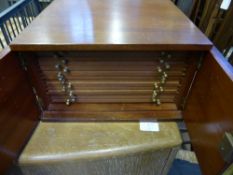 A Mahogany Coin Chest with fourteen interior coin fitted slides together with four olive wood