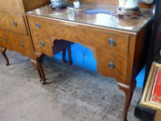 A teak kneehole dressing table by Raleigh Furniture having one long and two short drawers on