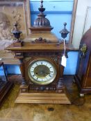 Oak HAC German Chiming Mantle Clock, the clock features an enamel dial with Roman numerals, the