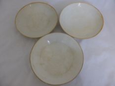 Three ivory coloured Quinbai bowls, featuring a duck, cow and lotus to the interior of the bowls.