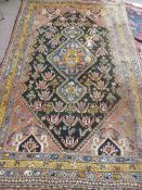 An antique Middle Eastern wool carpet having geometric design with floral border, pink ground with