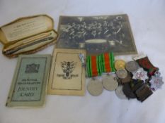 Two second world war Defence Medals in their original boxes and a silver identity bracelet and a