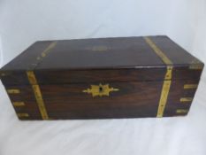 An antique rosewood writing box having two lift up slopes, one being fitted with three drawers