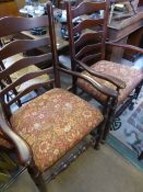 A set of six ladder back dining chairs with two matching carvers, the seats being of floral design.