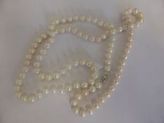 A long white large cultured pearl necklace, marked 14 k, approx. 89 cms. in length.