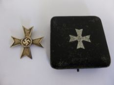 A Cased Die Struck German War Merit Cross 1st Class.  The obverse depicts a wreathed swastika on a