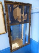 A gilt wood hall mirror with a carved wood silhouette to the top, approx. 74 x 41 cms. together