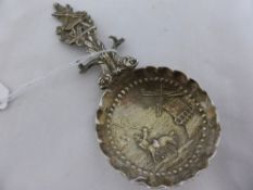 A mid 19th century Dutch silver hallmark Caddy Spoon, the bowl of the spoon chased with a windmill