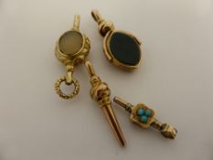 A collection of misc. antique pocket watch winders together with a mourning pendant set with