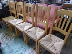 A Pine Breakfast Table with six straight back chairs and rush seat.