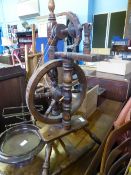 An antique oak spinning wheel, approx. 85 cms. high.