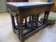 A Mahogany Nest of Tables on turned legs and stretchers.