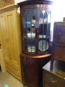 Antique Mahogany Astral Glaze Corner Cabinet, the bow fronted cabinet having inlaid panel doors to