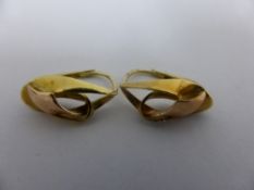 A pair of yellow gold and red knot clip on earrings, approx. 3 gms.