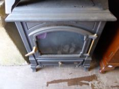 A Cast Iron Efe Wood Burner with Brass Handle and pin.