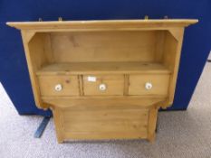 A reclaimed pine wall hanging shelf unit having an open shelf to the top with three drawers below