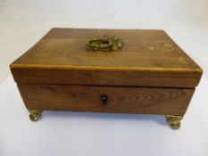 A Regency rosewood jewellery box having  gilded ring handles to the lid on claw feet with a silk